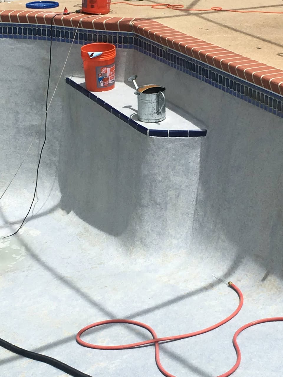 Close-up of drained pool wall freshly cleaned and brightened during acid wash service