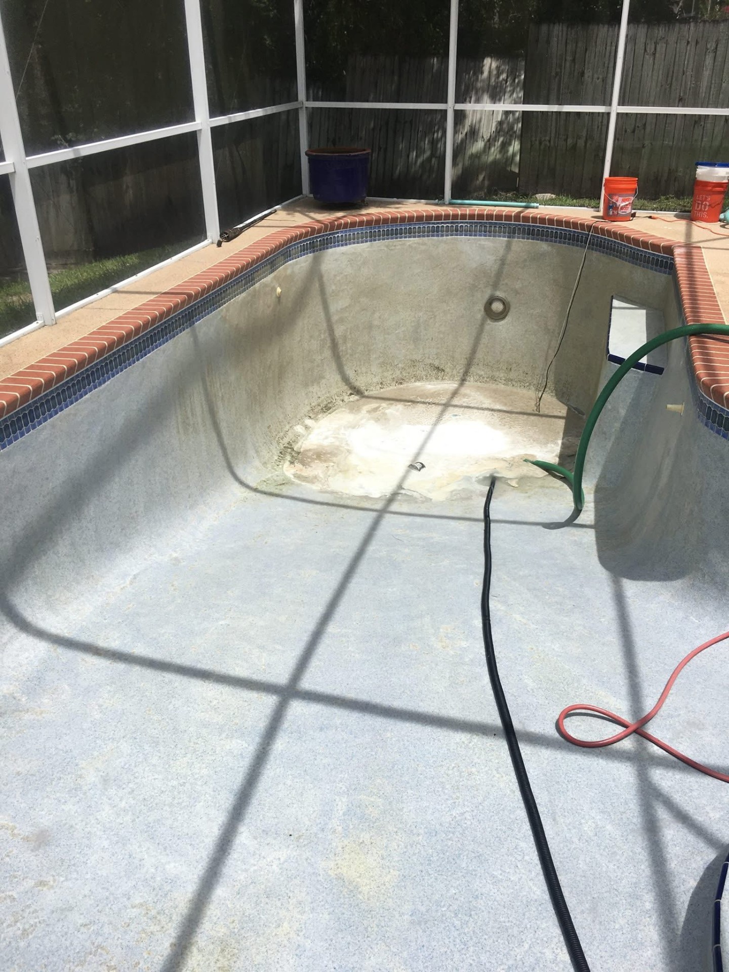 Drained stained pool before professional recovery