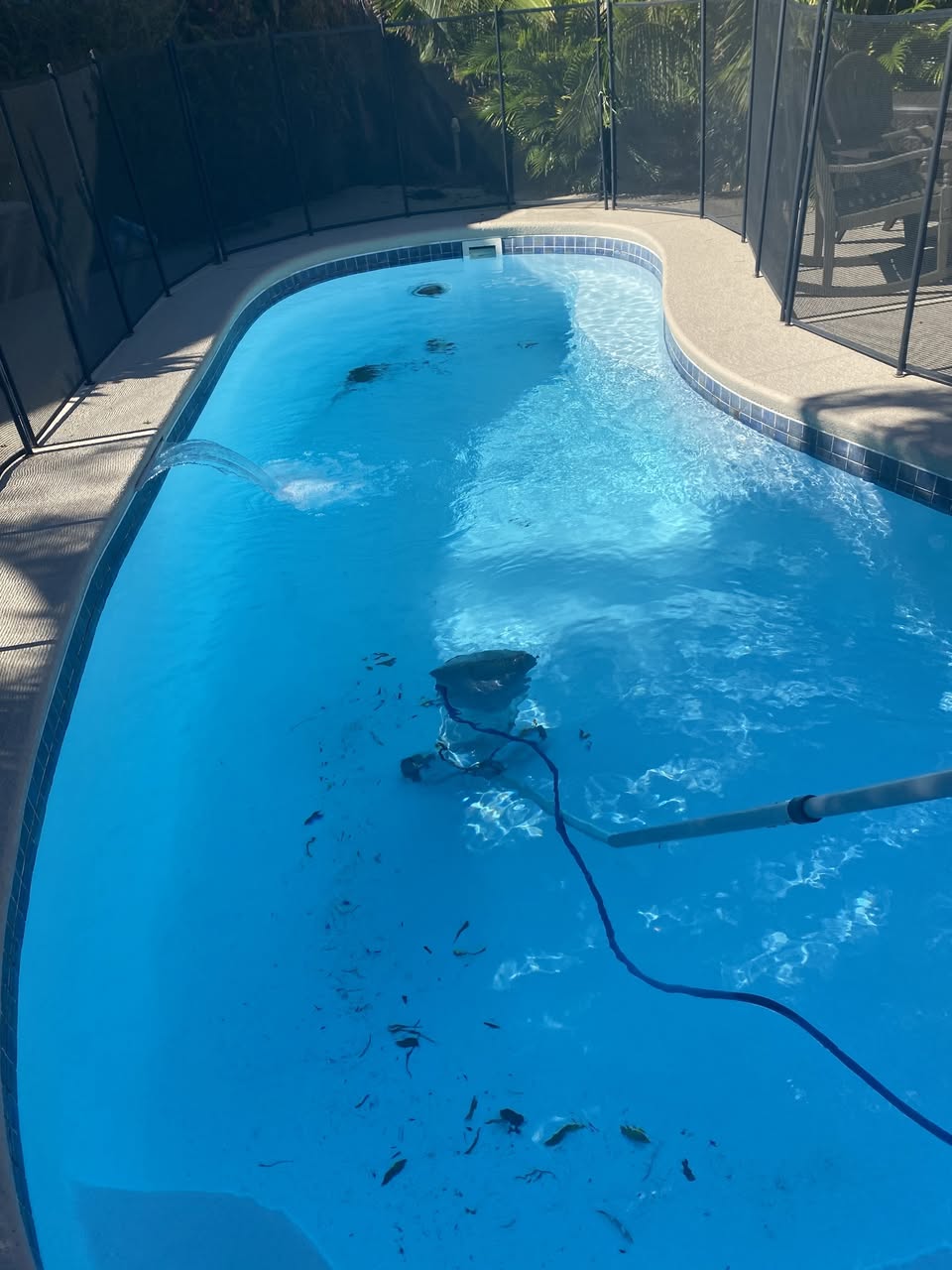 Bright blue Orlando customer pool being vacuumed with debris cleanup by Sunny Clean Pool