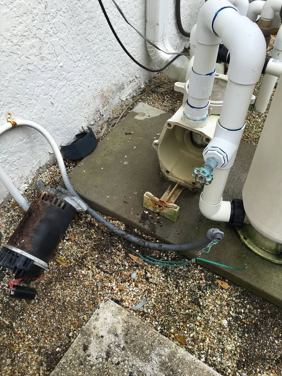 Failed rusted pool pump motor removed from Orlando equipment pad before replacement